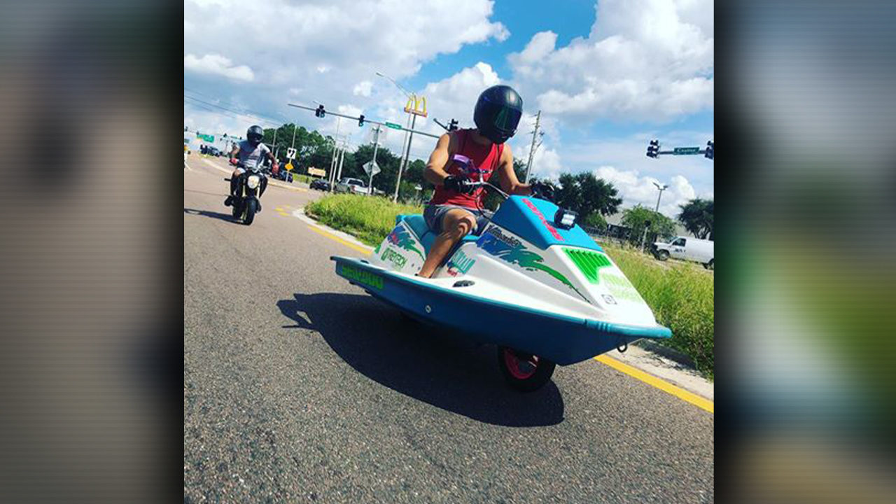 Man drives a jet ski on the road